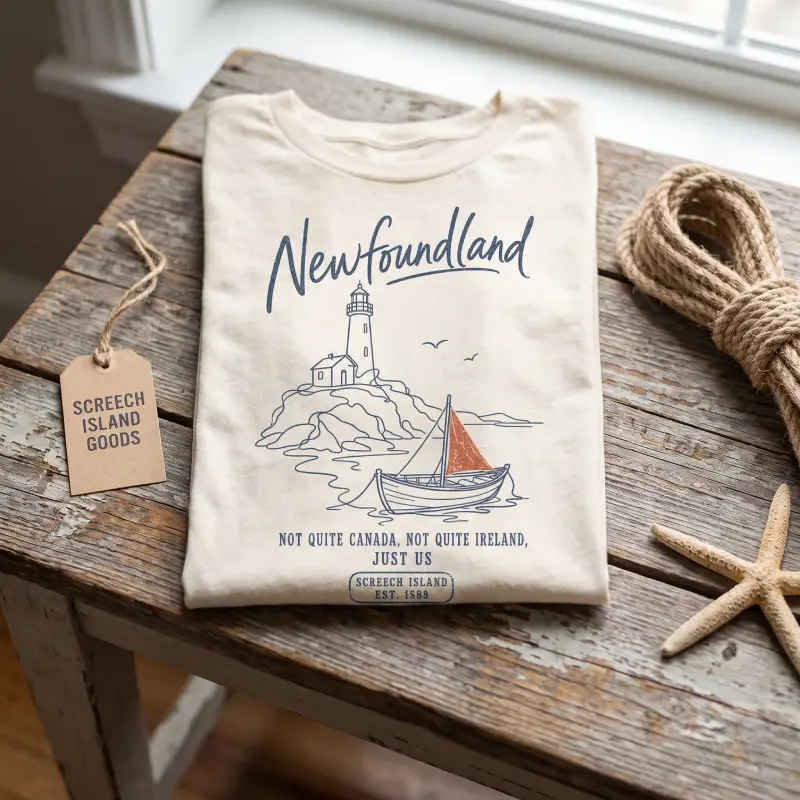 Newfoundland t-shirt folded on a weathered dock with rope and a starfish